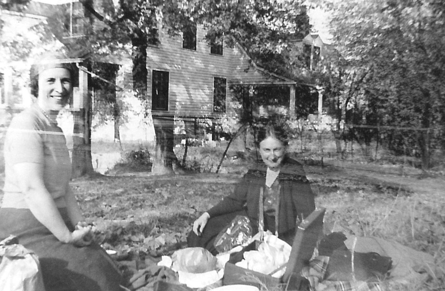 Black and white photo of two people having a picnic